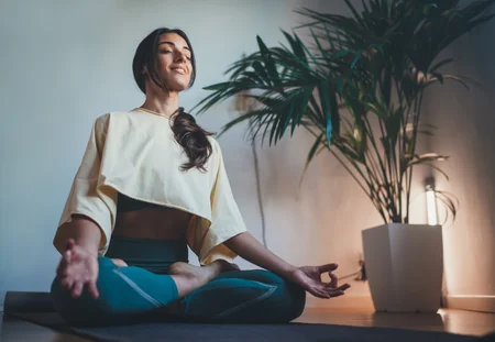 Young woman practicing yoga at home