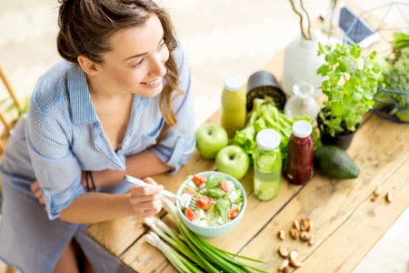 Young and happy woman eating healthy