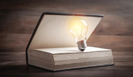 Light bulb and book. Knowledge and wisdom
