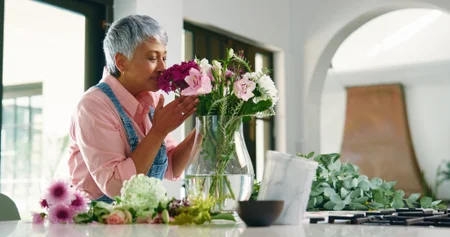 Senior woman smelling flowers