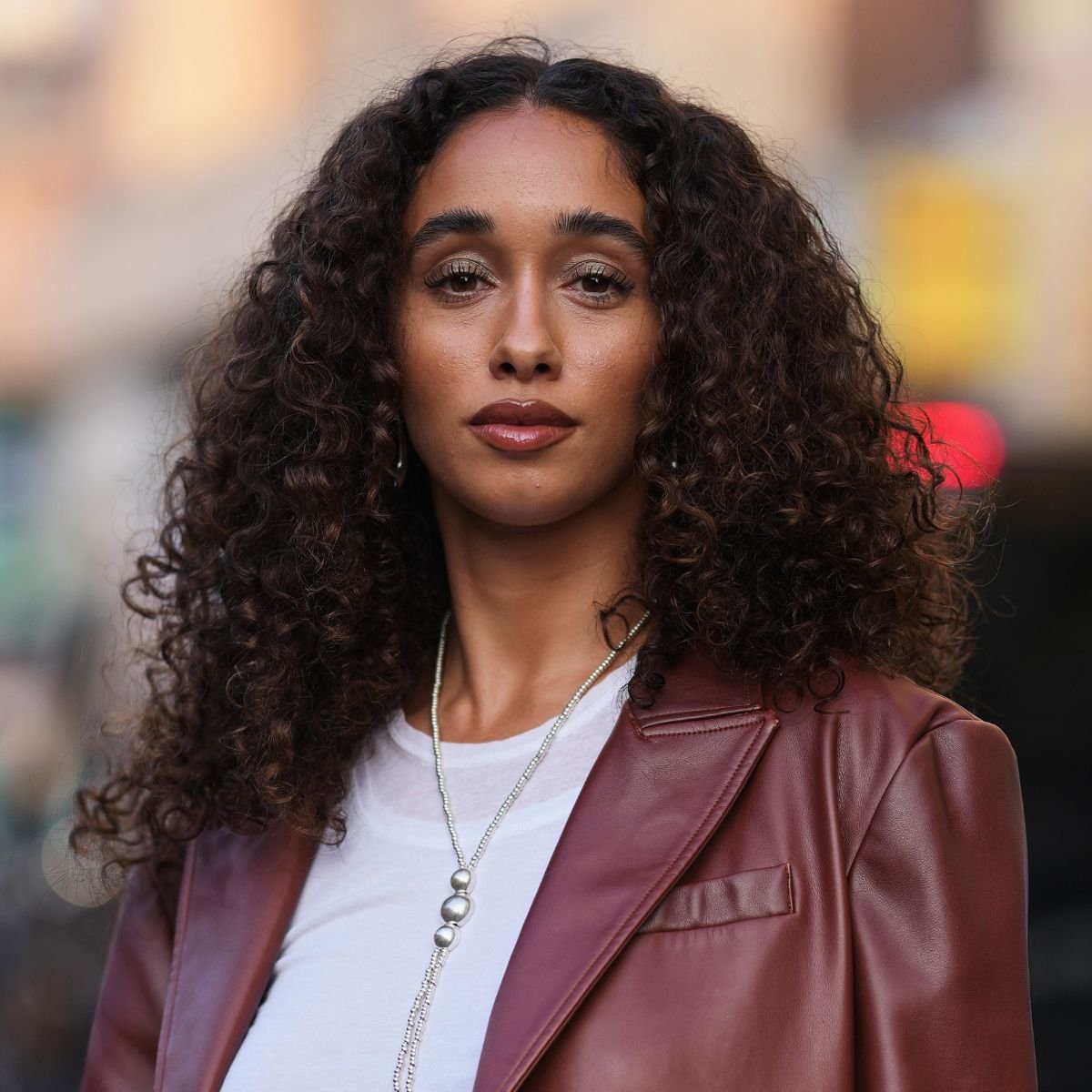 street style shot of woman with lob curly hair