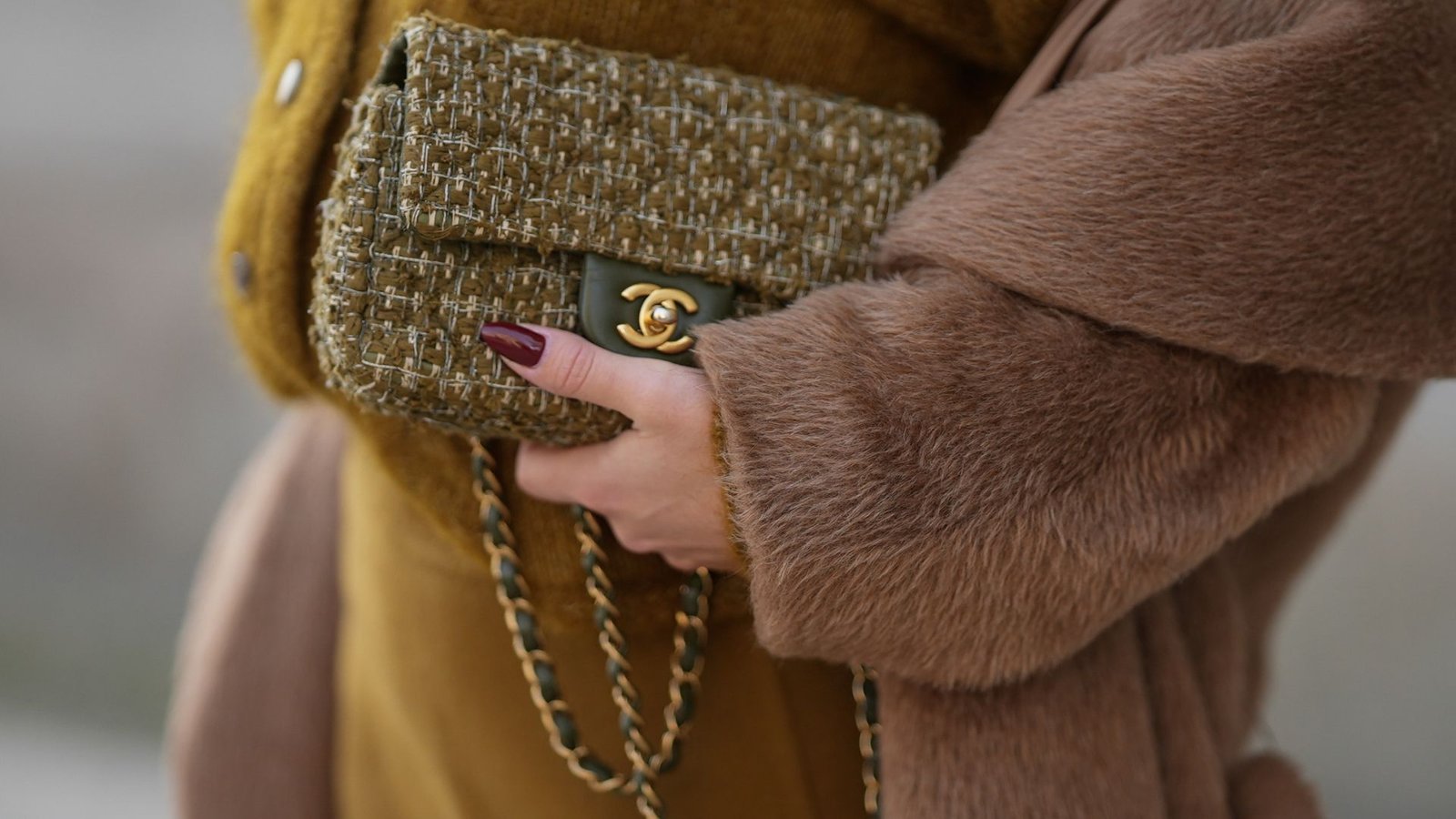 best nail shades for party season Laura Noltemeyer is seen wearing a a long camel-colored brushed wool coat with a wrap silhouette and integrated belt by Max Mara; a mustard-colored knit cardigan with a brushed cable-knit pattern and front button fastening by S&eacute;zane; a mustard yellow brownish mini skirt in a soft wool fabric by S&eacute;zane; a small quilted tweed flap bag in a khaki Color with woven fabric material with a gold chain strap and CC clasp by Chanel; her brown hair is styled in loose waves with a center part on November 13, 2025 in Hamburg, Germany